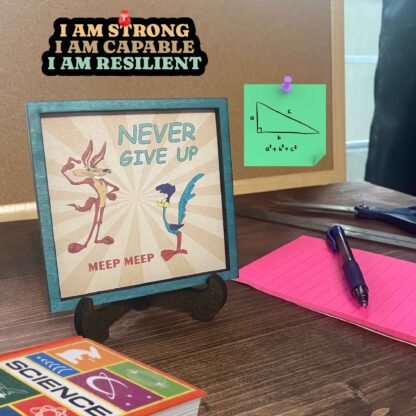 Mini frame with Road Runner burst-style background and the quote “Never give up, meep meep.”