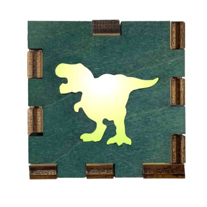 Green-stained wood light box with a T-Rex dinosaur cutout glowing from behind.