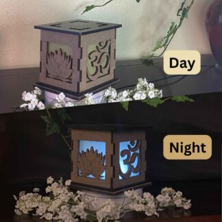 Serenity Om and Lotus Wooden 5" Light Up Gift Box that is cut through on two sides with colored filter to light up as it gets dark.