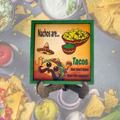 Mini frame with a desert background, a bowl of nachos, taco clip art, and the quote “Nachos are just tacos that don’t have their life together.” Green frame.
