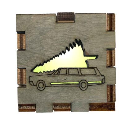 Christmas Vacation Interactive Light Box with grey-stained wood front showing classic station wagon and tree, glowing with yellow light.
